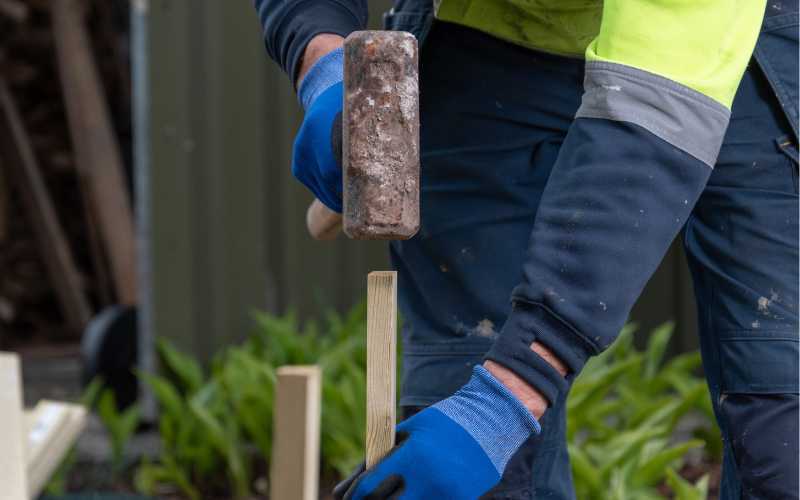 The traditional method of installing piles requires two or more laborers using large sledgehammers to drive the metal beams into the ground.