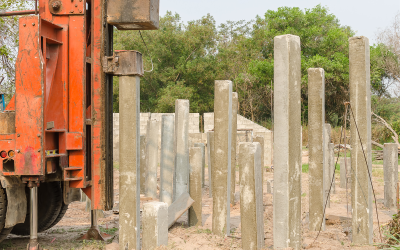 Solar pile drivers in action, efficiently installing support piles for solar panels in a large-scale solar farm.