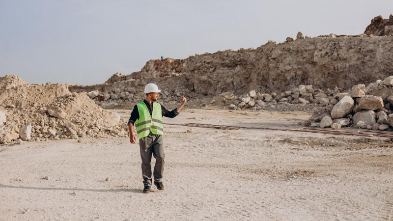 A worker in a rocky terrain