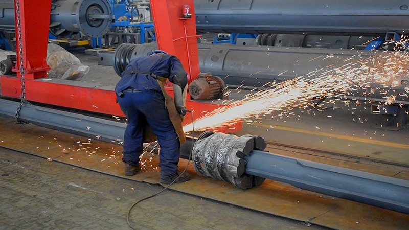 A worker is welding a kelly bar